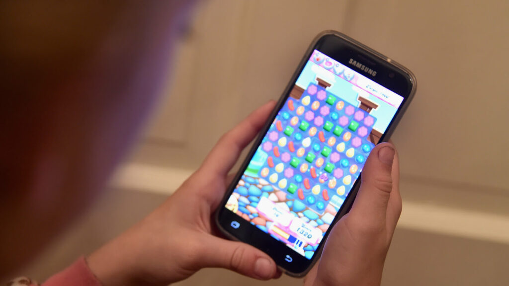 A person playing Candy Crush -- one of the best mobile games for gamers on the go