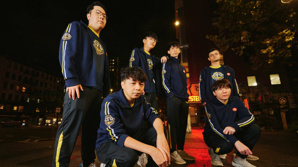 The image shows a group shot of League of Legends team CTBC Flying Oyster. The group of six Taiwanese men look solemnly at a ground-level camera