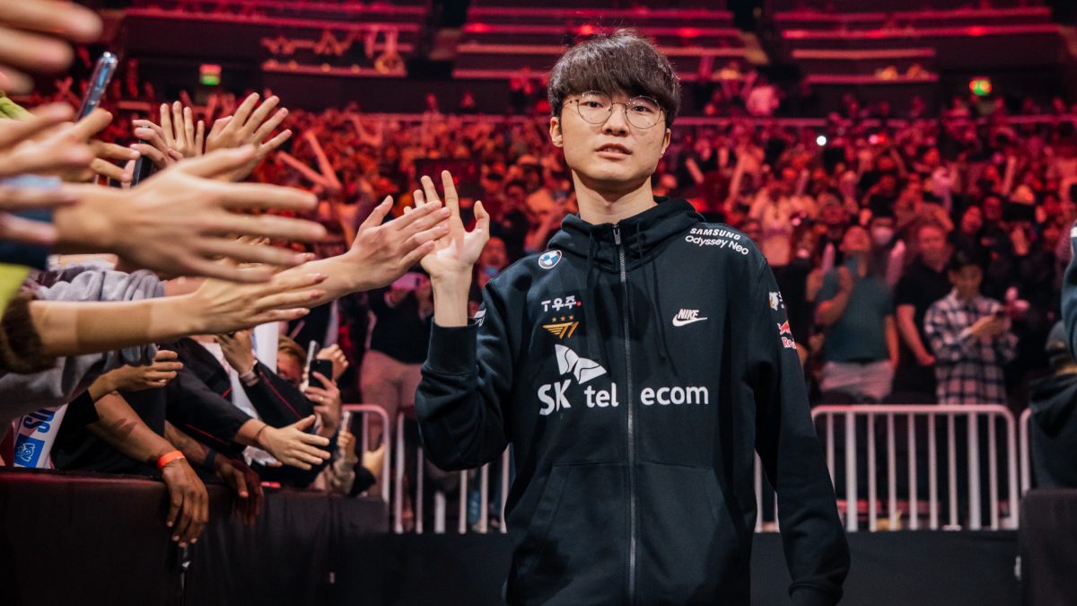 Image of League of Legends player Faker high-fiving fans at Worlds 2022