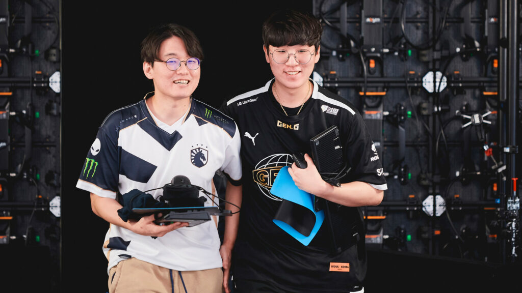 Image shows Team Liquid player CoreJJ walking with Gen.G player Ruler backstage at Worlds 2021. Both players are smiling.